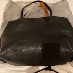 Black faux leather tote with brown inside